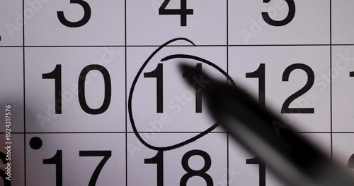 Footage of a calendar showing the date 11th reminder concept for the 11th day of the month with a black pen circling the date as a reminder of the day