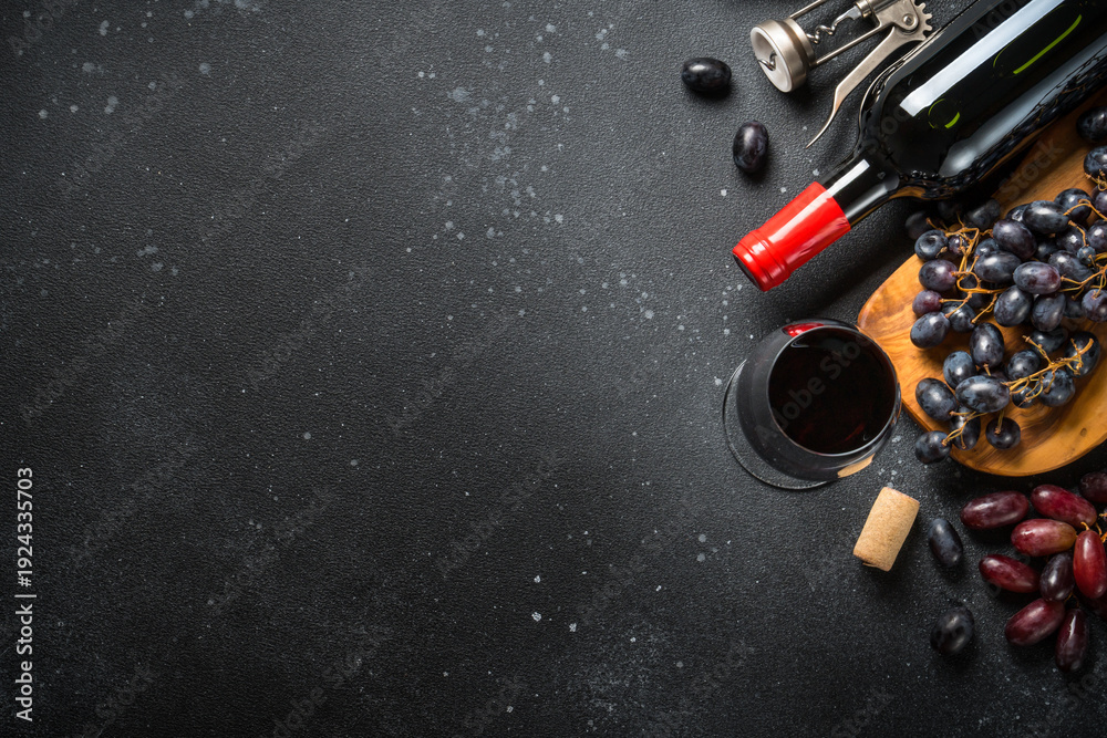 Obraz premium Red Wine at black background.