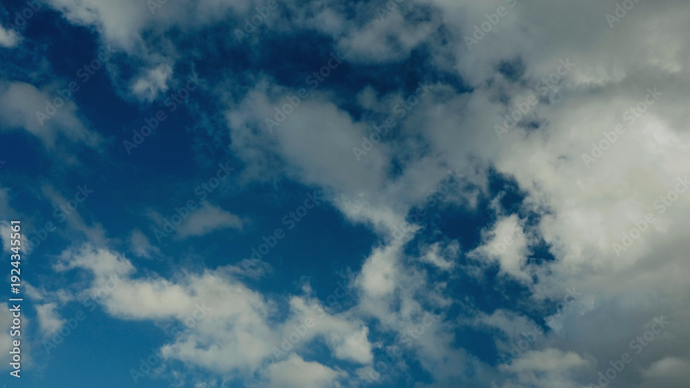 Obraz premium Cloud and sky view from above, and changes in daytime weather patterns.