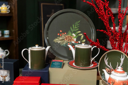 London, UK, 12 December 2026,    fortnum and mason. Luxury porcelain teapots and plates with green pattern displayed in a store.