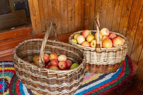 Wallpaper Mural Wicker baskets filled with apples on colorful rug  
 Torontodigital.ca