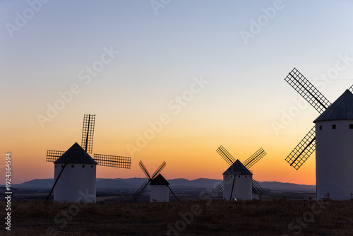Campo de Criptana windmills silhouetted against a colorful sunset