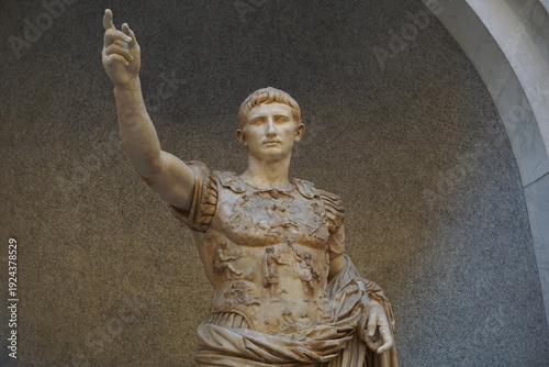 Frontal close up of a marble statue depicting the ancient Roman emperor Augustus giving a salute
