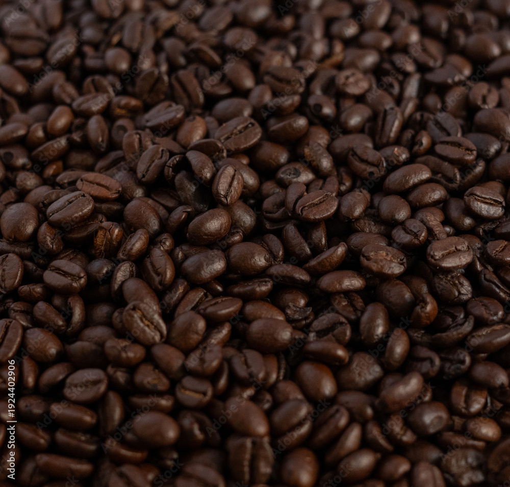 Fototapeta premium Roasted coffee beans macro texture background, full frame top view.