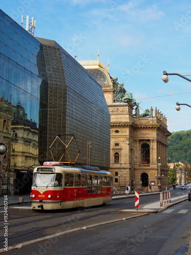 Prague Street Scene Modern & Historic Blend - Tram passing by the historic National Theatre and modern architectural buildings in Prague.