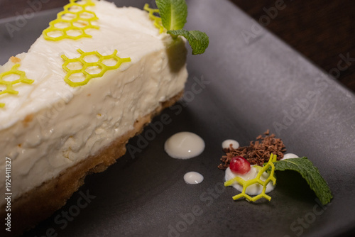 A slice of cottage cheese pie on a plate with beautiful decoration