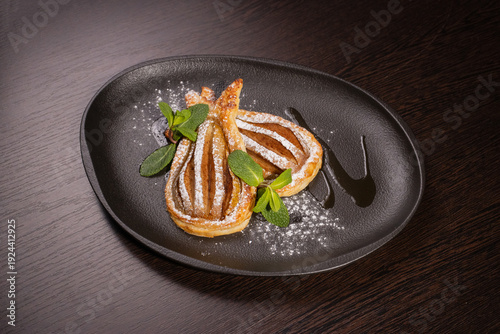 Dessert of fried pear sprinkled with powdered sugar
