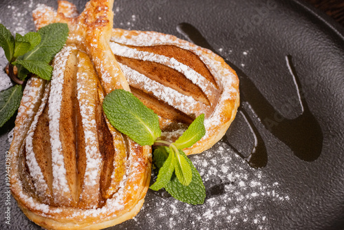 Dessert of fried pear sprinkled with powdered sugar