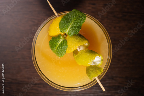 A alcoholic cocktail with orange juice is beautifully decorated by the bartender