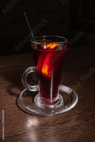 Mulled wine in a glass on a wooden table