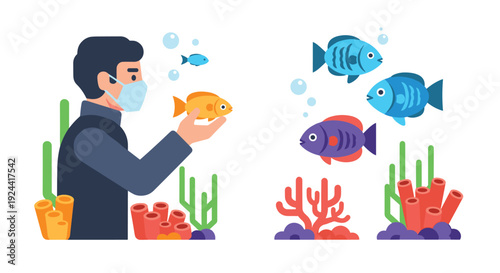 Man wearing face mask examines a small goldfish in an aquarium with coral and other fish