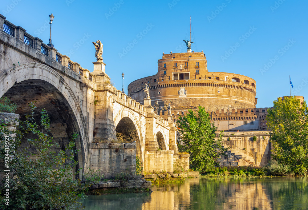 Fototapeta premium Castle of Holy Angel (Castel Sant'Angelo) and St. Angel bridge (Ponte Sant'Angelo) over Tiber river in Rome, Italy