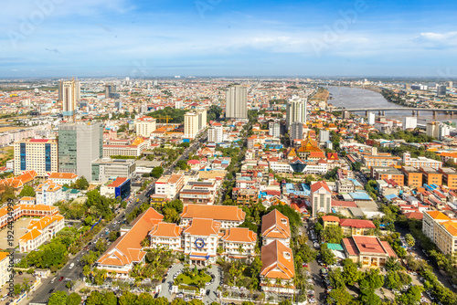 Modern residential areas and office buildings with Tonle Sap river in the background in rapidly developing Phnom Penh city panorama, Cambodia