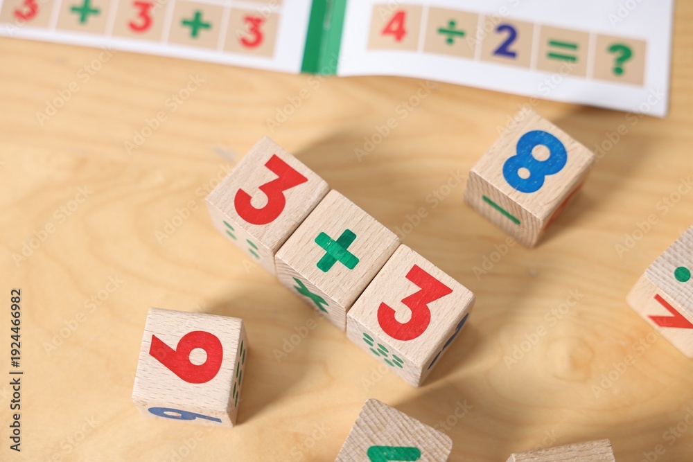 Fototapeta premium Wooden cubes with mathematical formula on table, above view