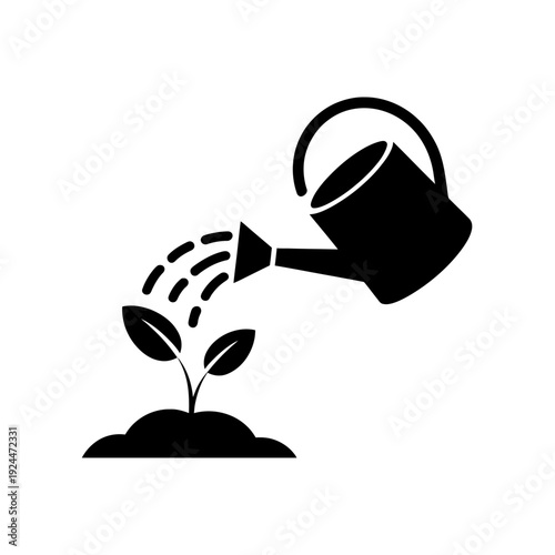 Black silhouette of watering can pouring water on young plant growing in soil