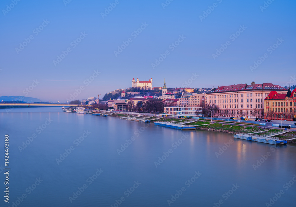 Obraz premium Bratislava Castle and Historic Riverside Buildings on Danube River