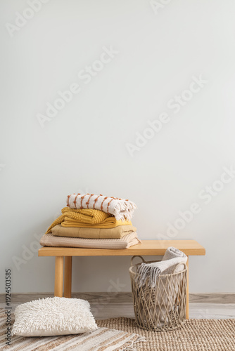 Stack of cozy plaids on ben...