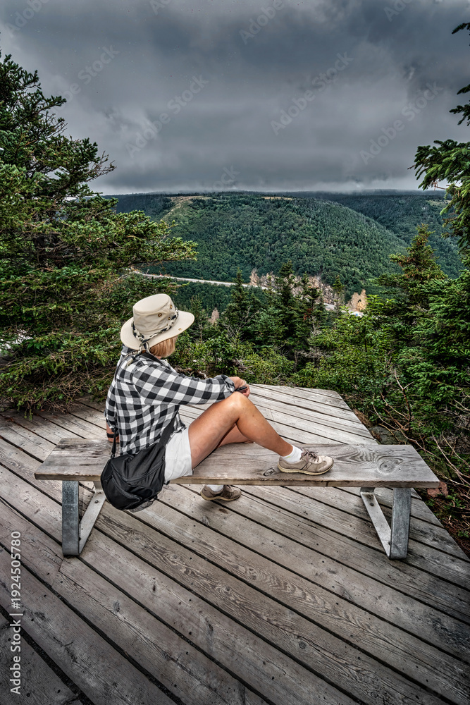 Fototapeta premium Hiker Resting at Scenic Lookout on Coastal Hiking Trail