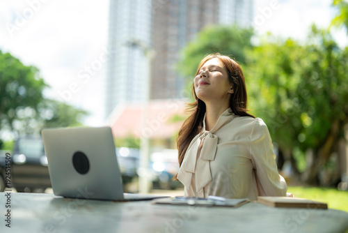 Free Download Woman relaxing outdoors with laptop enjoying fresh air - GFXLoad