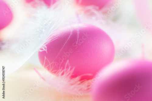 Easter eggs wallpaper.Delicate pink Easter eggs surrounded by soft white feathers in pastel tones.Easter mood.Orthodox and Christian symbol of the holiday.Easter food.minimal aesthetic spring