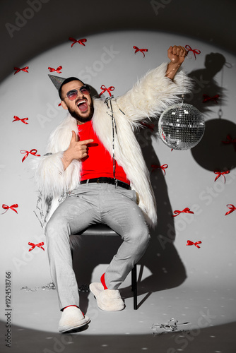 Happy young man with disco ...