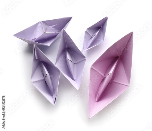Lilac paper boats on white ...