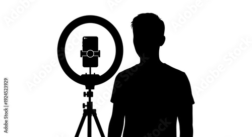 Silhouette of content creator standing in front of ring light and smartphone on tripod