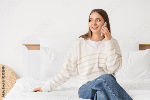 Young woman talking by mobi...