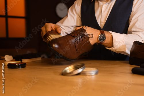 Man polishing shoe with bru...