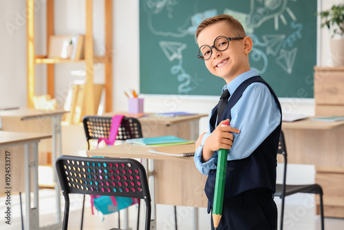 Cute little schoolboy with ...