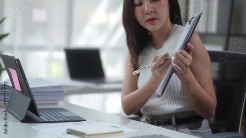 Businesswoman discussing documents during an online video conference