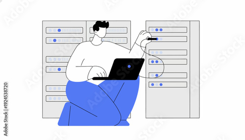 Man sitting with laptop interacting with large computer servers