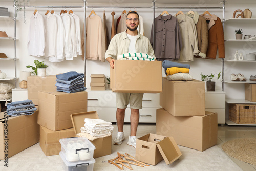 Young man with wardrobe box...