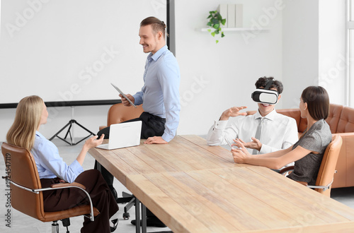 Young businessman using VR ...