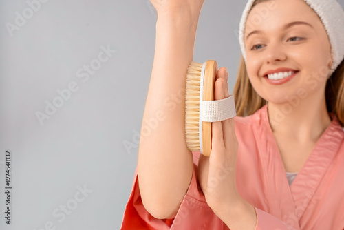 Young woman massaging her a...