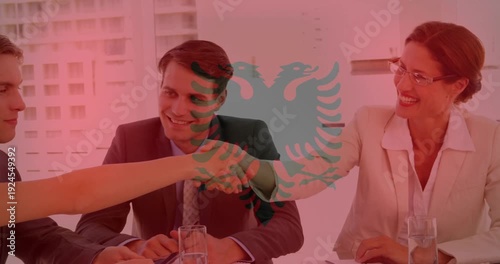 Business team meeting, female reaching to entrant on arrival, handshaking under red emblem overlay