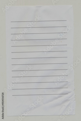 Wide Ruled notebook paper with ripped edge and crinkles