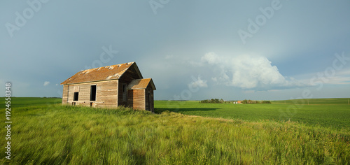 An abandoned decaying home on a stormy summer evening in Alberta, Canada.