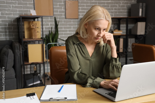 Worried mature businesswoma...