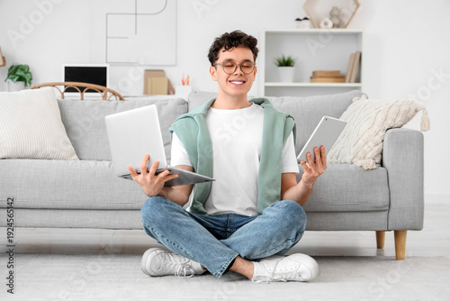 Young man with laptop and t...