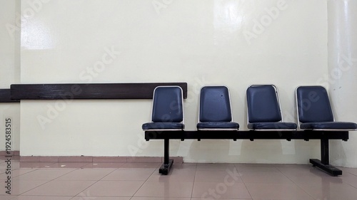 Quadro em tela Unoccupied waiting chairs arranged neatly along a wall, reflecting calm atmosphere, public service environment, healthcare visit, travel delay, or administrative process