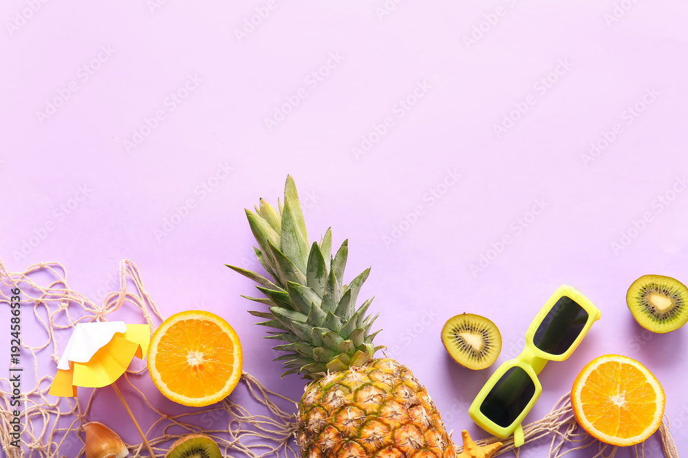 Obraz premium Fresh pineapple with orange, kiwi, umbrella and sunglasses on lilac background
