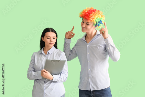 Business man in clown wig w...