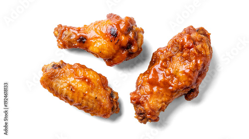 Tableau sur toile a close-up studio shot captures three delicious barbecue chicken wings and a drumstick, glistening with sauce and char marks, isolated on a plain transparent background