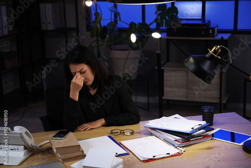 Tired Asian businesswoman s...