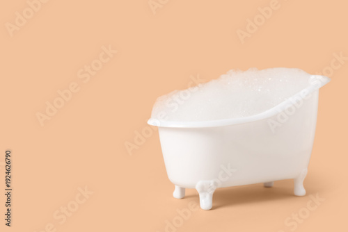Small bathtub with foam on ...