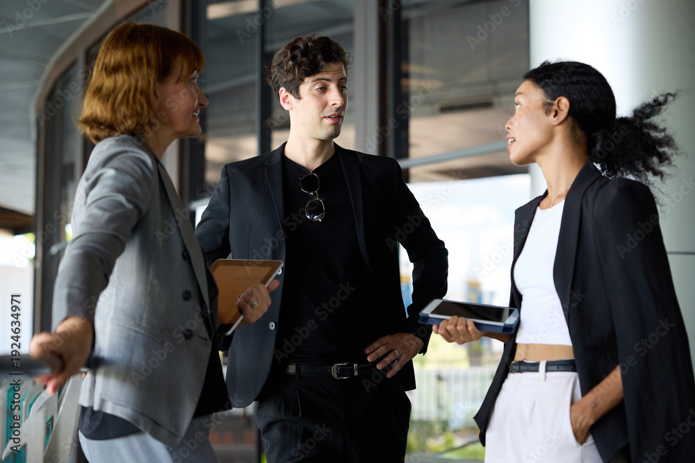 Fototapeta premium Business colleagues engage in a thoughtful discussion in a modern office setting