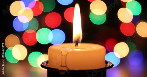 Wallpaper Mural A glowing candle with a flickering flame surrounded by colorful bokeh lights in the background Torontodigital.ca