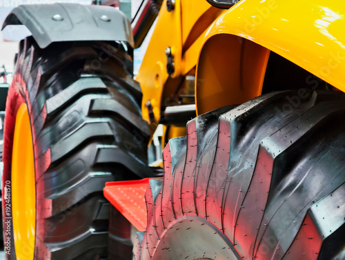 Fotografie Close-up view of robust construction equipment wheels showcasing tread design an