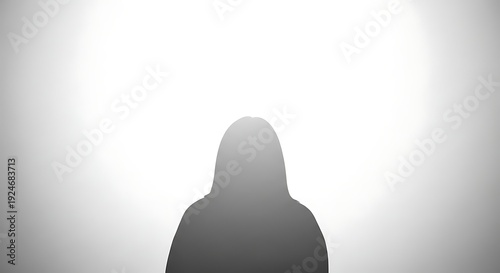 Silhouette of a person standing against a bright background